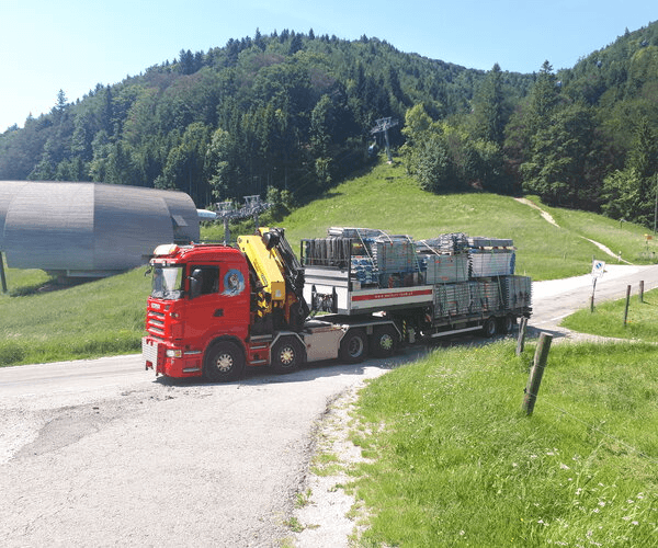 Red truck with specialized trailer carrying industrial equipment - Walker's Team special transport service