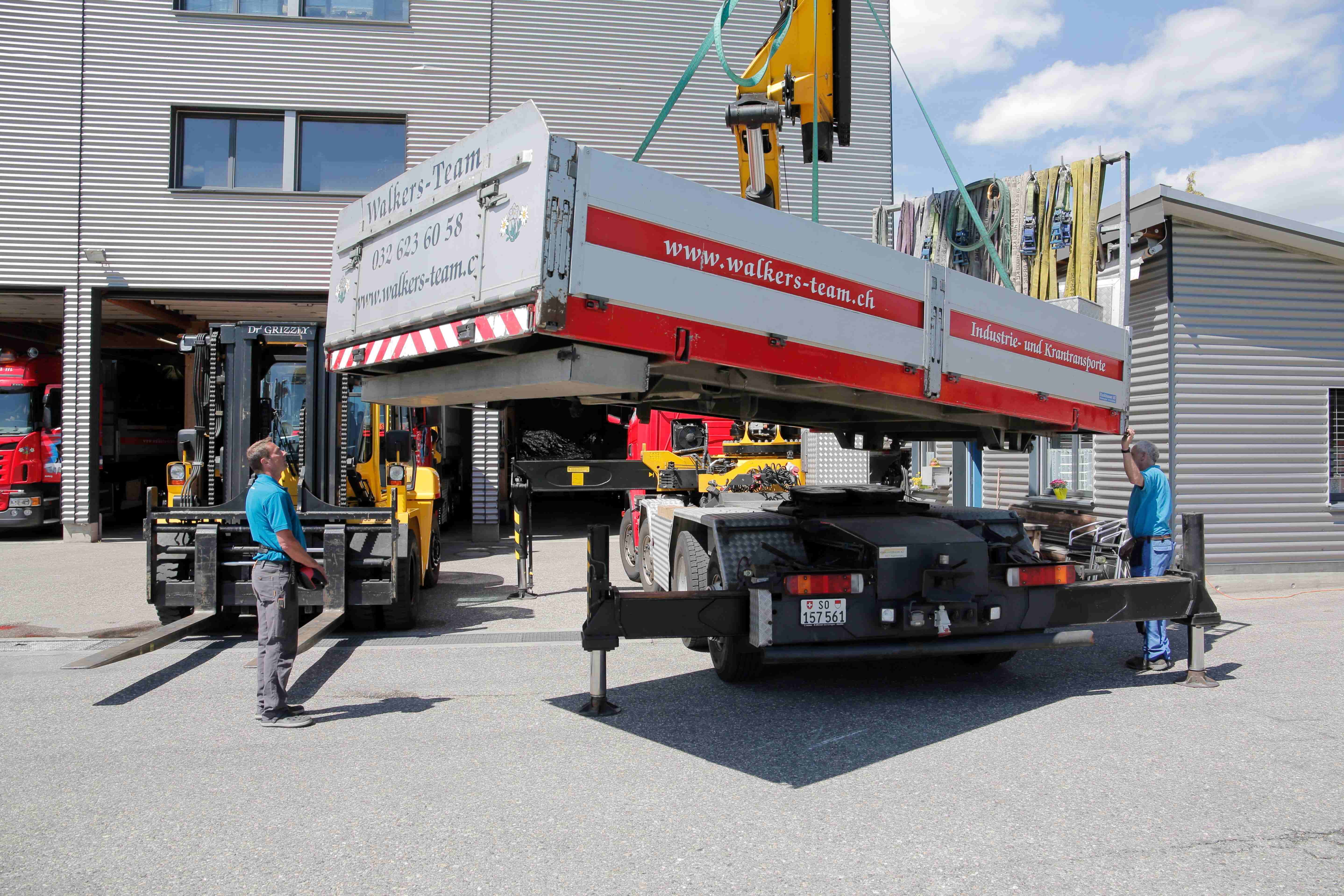 Walker's Team crane operation with workers and branded equipment